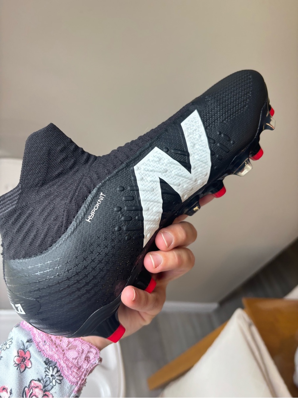 New Balance Black Soccer Cleat with White Logo and Red Stud Accents - Picture 2 of 5